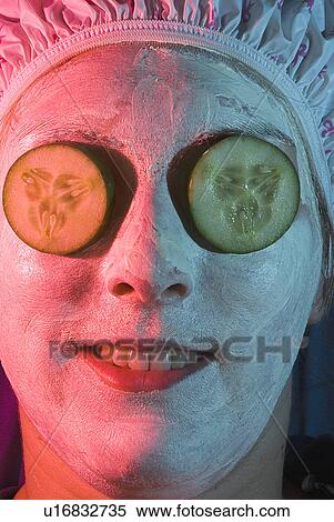 Stock Photography - Face treatment with cucumbers. Fotosearch
