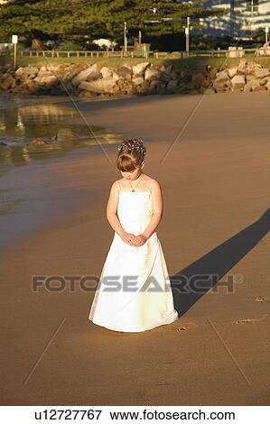 Stock Photo - Flower girl on beach. Fotosearch