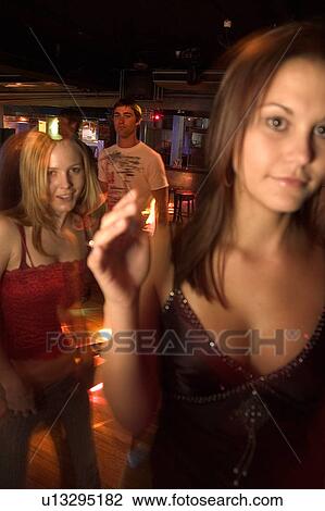 Stock Image - Friends at nightclub. Fotosearch