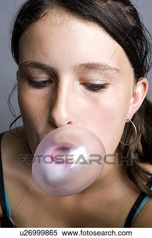 Stock Photography - Girl blowing bubblegum. Fotosearch