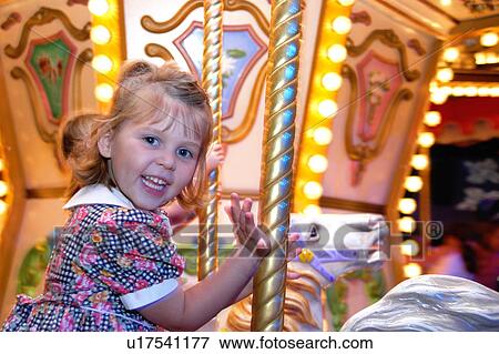 Girl on a merry-go-round View Large Photo Image Stock Photo - Girl on a merry-go-round. Fotosearch