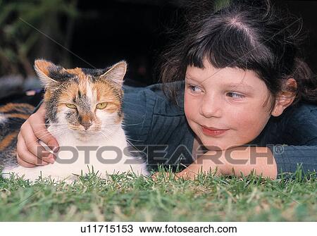 Stock Image - Girl with pet cat. Fotosearch
