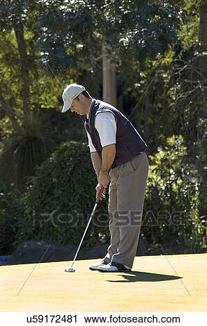 Stock Image - Golfer putting. Fotosearch