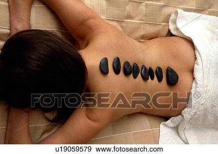 Stock Photo - Hot rock massage. Fotosearch