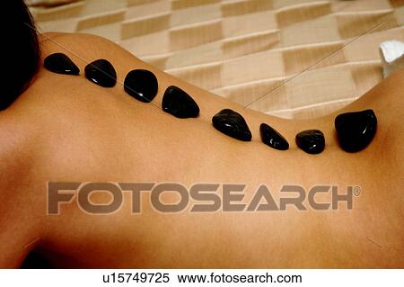 Hot rock massage View Large Photo Image Stock Photography - Hot rock massage. Fotosearch
