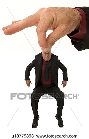 Huge hand holding a businessman View Large Photo Image Stock Image - Huge hand holding a businessman. Fotosearch