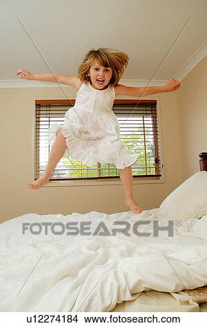 Jumping on the bed View Large Photo Image Picture - Jumping on the bed. Fotosearch