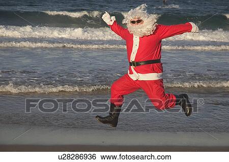 Stock Photograph - Jumping Santa.. Fotosearch