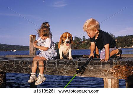Kids fishing with a dog View Large Photo Image Stock Image - Kids fishing with a dog. Fotosearch