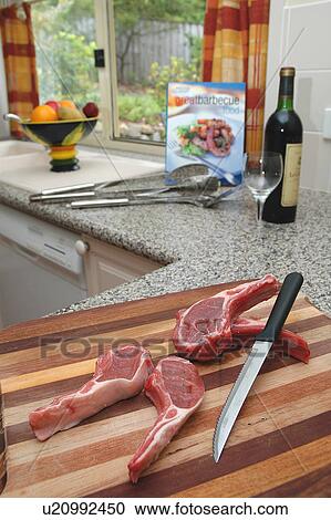 Stock Image - Lamb chops in kitchen. Fotosearch