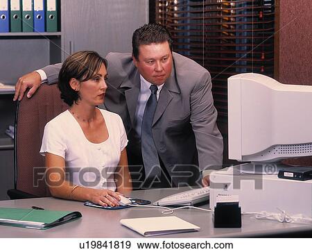 Man and woman work at computer View Large Photo Image Stock Photo - Man and woman work at computer. Fotosearch