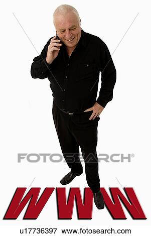 Man on a cell phone standing on WWW View Large Photo Image Stock Photo - Man on a cell phone standing on WWW. Fotosearch