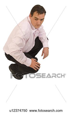Man squatting View Large Photo Image Stock Image - Man squatting. Fotosearch