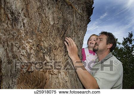 Stock Photography - Man teaching a girl about trees. Fotosearch