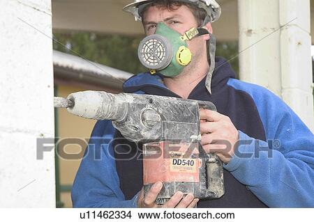 Mason using a drill View Large Photo Image Picture - Mason using a drill. Fotosearch
