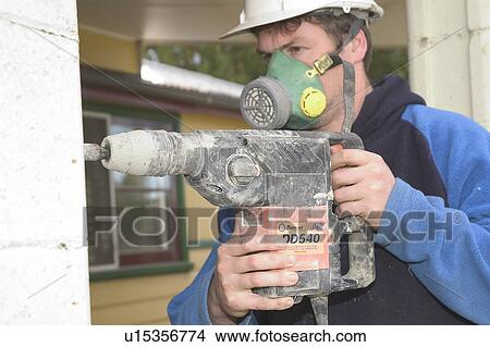 Mason using a drill View Large Photo Image Picture - Mason using a drill. Fotosearch