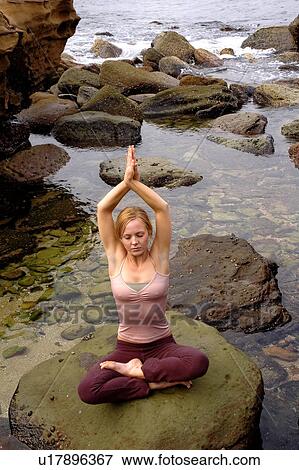 Stock Photo - Meditating by the ocean. Fotosearch