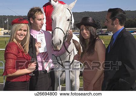 Stock Image - Meeting a horse at the races. Fotosearch