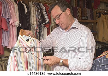 Stock Photo - Mens clothes shopping. Fotosearch
