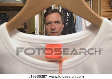 Stock Photo - Men's clothes shopping. Fotosearch