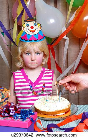 Stock Image - Not so happy birthday girl. Fotosearch