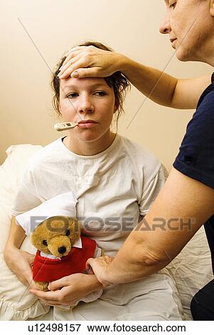 Stock Photo - Nurse treating a teen. Fotosearch