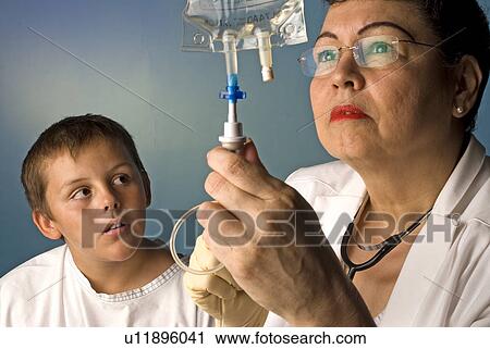Nurse with boy patient View Large Photo Image Stock Image - Nurse with boy patient. Fotosearch