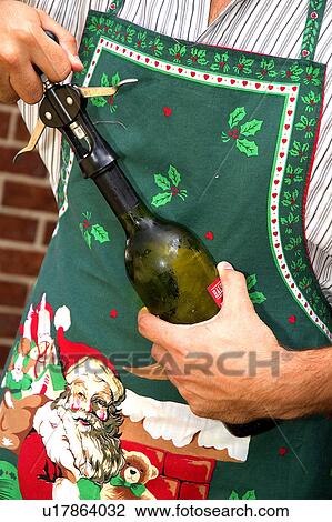 Stock Image - Opening a bottle of wine. Fotosearch