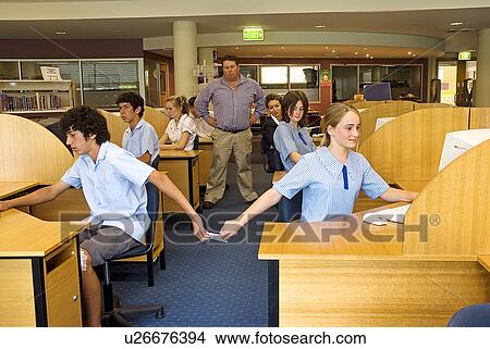 Picture - Passing notes in class. Fotosearch