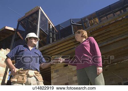 Paying a construction worker View Large Photo Image Stock Photo - Paying a construction worker. Fotosearch