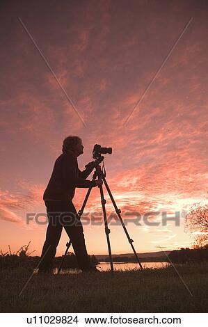 Picture - Photographer taking an outdoor photo. Fotosearch
