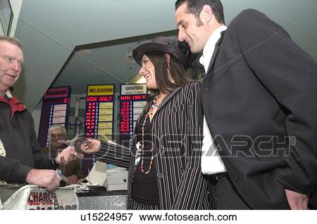 Stock Photo - Placing a bet at a track. Fotosearch