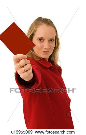 Stock Photo - Red card being held by a woman in a red coat. Fotosearch