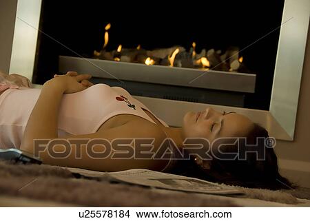 Picture - Relaxing by the fire. Fotosearch