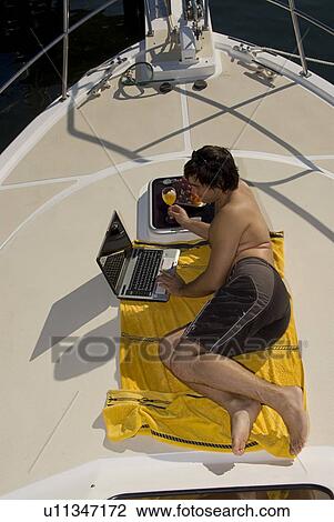 Stock Image - Relaxing on deck. Fotosearch