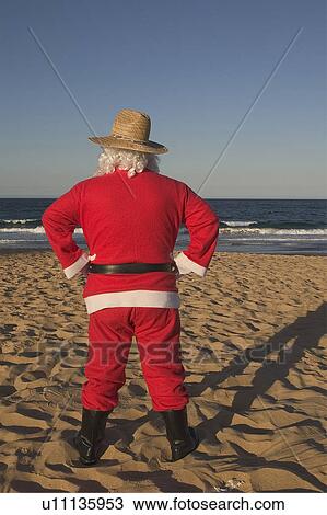Stock Image - Santa at beach. Fotosearch