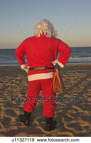Stock Photo - Santa at beach. Fotosearch