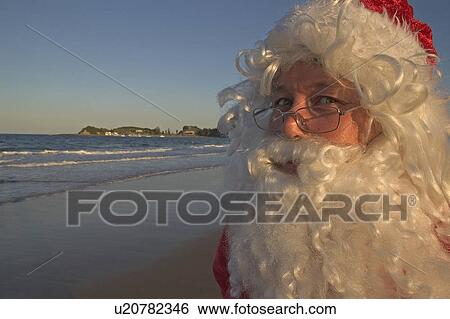 Stock Photograph - Santa at beach. Fotosearch