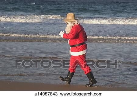 Stock Image - Santa beach stroll. Fotosearch