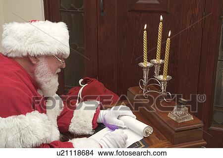Picture - Santa checking his list. Fotosearch