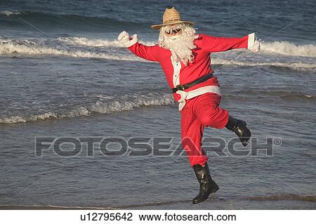 Stock Image - Santa clicking heels. Fotosearch