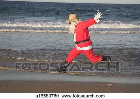 Stock Image - Santa jumping. Fotosearch