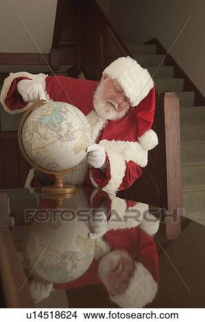 Picture - Santa planning his trip. Fotosearch