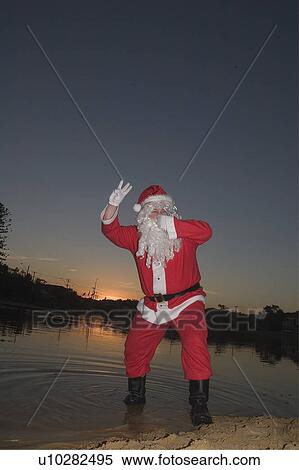 Stock Photography - Santa pretending to drown. Fotosearch