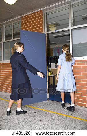 Senior showing junior around the school View Large Photo Image Stock Image - Senior showing junior around the school. Fotosearch