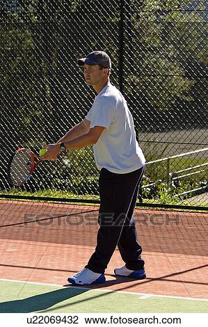 Stock Image - Serving in tennis. Fotosearch