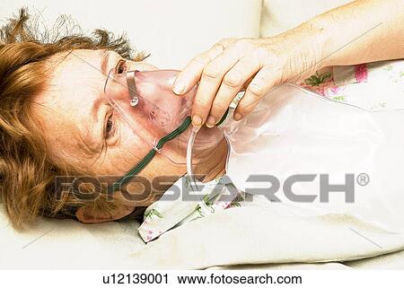 Sick woman getting oxygen View Large Photo Image Stock Image - Sick woman getting oxygen. Fotosearch