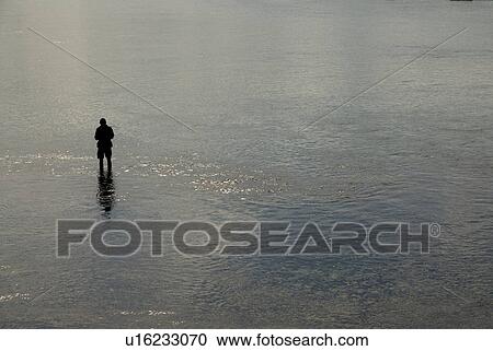 Stock Image - Single fisherman. Fotosearch