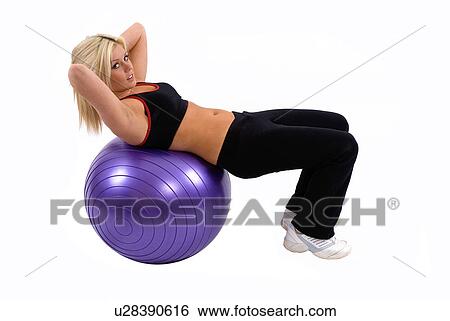 Stock Photograph - Situps on fitness ball. Fotosearch