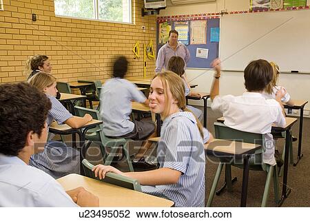 Stock Image - Student poking her tongue out. Fotosearch